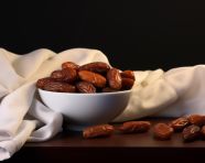 Datessafeer or dates in white bowl on table, sweet dates image