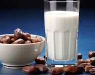 Glass of milk and dates next to a blue background, sweet dates image