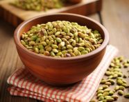 Pistachio snack on a wooden surface, pistachio nut image