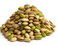 A pile of pista nuts on a white surface, pistachio nut image