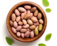 Pistachios in a wooden bowl on a white background, pistachio nut image