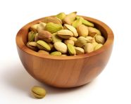 Pistachio nuts in a wooden bowl with white background, pistachio nut image