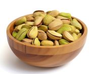 Pistachio nuts in wooden bowl isolated on white background, pistachio nut image