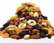 A pile of dried fruits and nuts are shown white background, dry fruits mix image