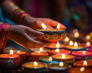 Female hands lighting small tea light candles during diwali, diwali festival stock image, diwali festival ai prompt