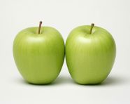 Two green apples with one cut in half and one on a white background, apple fruit image hd