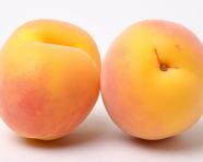 Two ripe apricots are open on a white background, apricot images