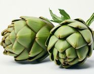 A pair of green artichokes on a white surface, artichoke image