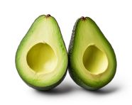 Two avocados with half of them cut in half on white background, avocado image stock photo
