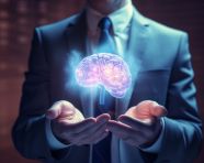 A businessman with a brain on his hand holding up paper, human brain image