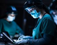 Female surgeon working on laptop, medical images stock