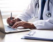 Healthcare worker recording notes, medical images stock