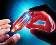 Hand reaches for glowing vial of medicine, medical images stock