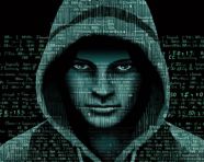 A hacker is shown in a hoodie, ascii style art