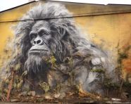Gorilla perched on building ledge, 3d graffiti art