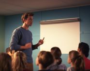 A student giving a presentation to the class, education