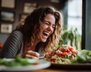Young woman eating healthy food sitting in the beautiful restaurant