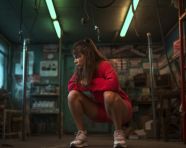 A woman doing some squats in the gym