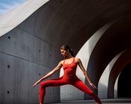Woman doing yoga on black surface
