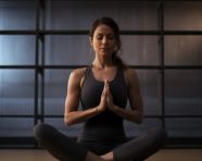 A woman doing a yoga pose in her gym