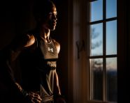 The athletes are silhouetted against a backlit window