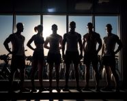 Athletes in motion against light