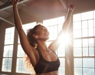 The woman is wearing a sports bra and leggings