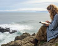 Womans thoughts take flight over the ocean