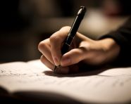 Students hand capturing a thought