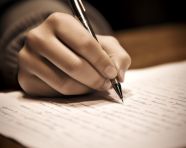 Student's hand writing notes