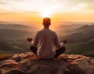 A person sitting cross-legged on a mountaintop