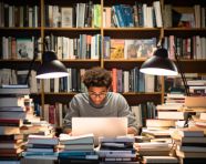 A student sitting at a table in the library