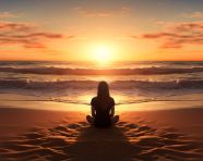 A person sitting on a beach watching the waves roll in