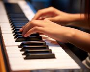 A close up of a student play on piano keyboard