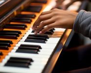 Woman plays an electric piano close up hands