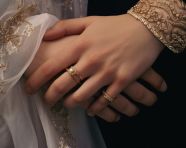 A close-up of the bride and groom hands