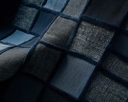 An image of fabric with squares made of denim