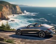 A car is parked on a cliff overlooking the ocean