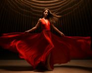 Woman in red dress dancing passionately