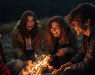 Friends laughing and talking under the stars